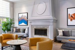 a living room with a fireplace and couches at Kimpton Hotel Monaco Salt Lake City, an IHG Hotel in Salt Lake City