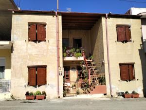 a building with brown doors and a staircase on it at Old House in Paradeísion