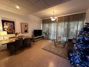 a living room with a christmas tree in it at Peaceful home near beach & car in Dubai