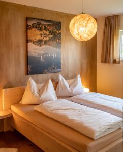 a bedroom with a large bed with white pillows at Haus LandArt in Schladming