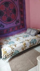 a bed in a room with a purple wall at B&B centro di livorno in Livorno