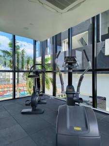 a gym with three exercise bikes in a building at Urban Suites - George Town, Penang in Jelutong