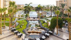 an aerial view of a resort with a pool and palm trees at Tropitel Sahl Hasheesh in Hurghada