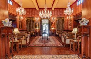 a living room with chairs and a chandelier at The Ajit Bhawan - A Palace Resort in Jodhpur
