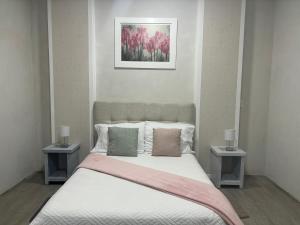 a bedroom with a bed with two side tables at Hotel Del Real in San Mateo Xoloc