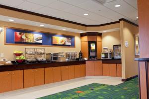 a fast food restaurant with a counter with food at Fairfield Inn and Suites Flint Fenton in Fenton