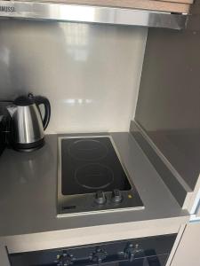 a stove top oven with a tea kettle on it at Magic Appartement Luxury Gauthier 10 in Casablanca