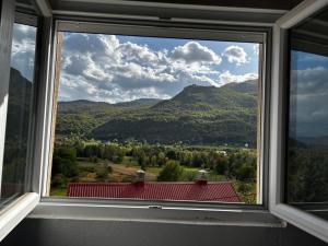a window with a view of a mountain view at Apartment Marojevic Lipovo in Kolašin