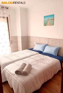 a bedroom with a bed with two towels on it at Blue Sky Montblanc - Swimming Pool & AC in Salou
