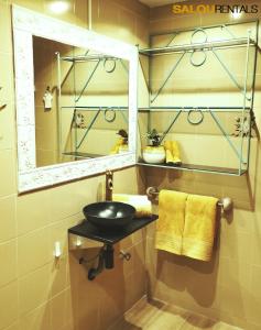 a bathroom with a sink and a mirror at Blue Sky Montblanc - Swimming Pool & AC in Salou +5 photos