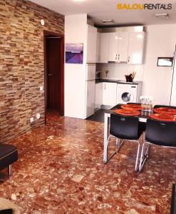a kitchen with a table and chairs in a room at Blue Sky Montblanc - Swimming Pool & AC in Salou
