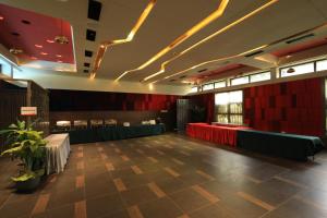 a dining room with red walls and a table at Hummingbird Resort in Mount Ābu +85 photos