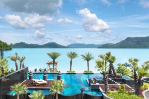 a view of the water at a resort with palm trees at The St. Regis Langkawi in Kuah