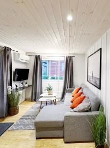 a living room with a couch and a table at Ystad Holiday Houses in Ystad