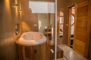 a bathroom with a sink and a mirror at Mundarium - Chalés Temáticos com Hidromassagem e Cromoterapia in Santo Antônio do Pinhal +70 photos