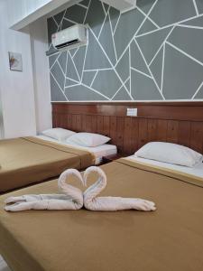 Postel nebo postele na pokoji v ubytování Pangkor BeachWalk Studio