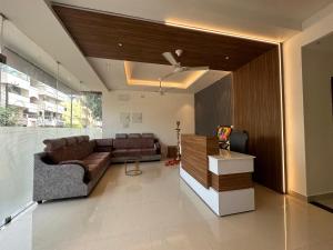 a living room with a couch and a table at SRI KRISHNA RESIDENCY in Tiruchchirāppalli