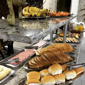 a buffet of food with sandwiches and other foods at HOTEL CÁ DEI MONTI in Serafina Corêa