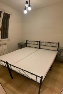 a bed in a room with a white mattress at Villa Kara in Lido degli Scacchi