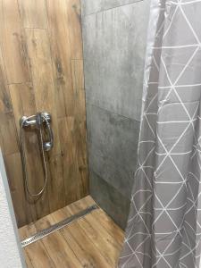 y baño con ducha y puerta de cristal. en Útulný byt Brezno v Nízkych Tatrách en Brezno