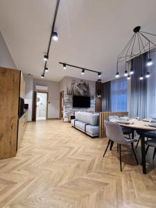 a living room with a table and a couch at Apartamenty Sebastiana in Kraków