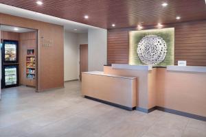 a lobby of a hotel with a reception desk and a painting at Fairfield Inn & Suites by Marriott Athens-University Area in Athens