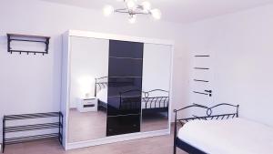 a bedroom with two bunk beds and a mirror at Apartament u Anielki in Uniejow