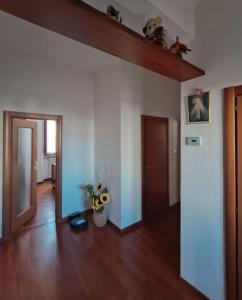 a living room with a hard wood floor and a hallway at Cuore di Toscana in Pistoia