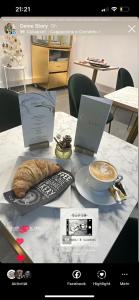 a table with two laptops and a pastry on it at Café Cuore in Sankt Margrethen