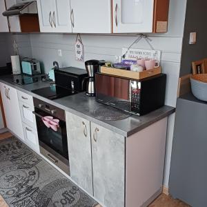 a kitchen with a counter top with a stove top oven at Apartament na nowej starówce in Kołobrzeg