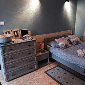 a bedroom with two beds and a dresser at Apartament na nowej starówce in Kołobrzeg