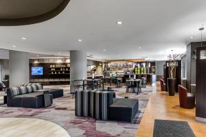 a lobby of a hotel with chairs and tables at Courtyard Columbus Easton in Columbus