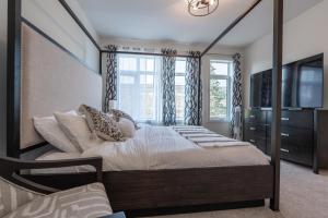 a bedroom with a canopy bed and a window at Room 1 of Lovely Montgomery Home, downtown Calgary in Calgary
