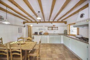 a kitchen with a table and a dining room at Can Valencià in Montecristo