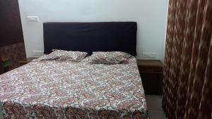 a bed with two pillows on it in a bedroom at Niks home stay - A in Trichūr