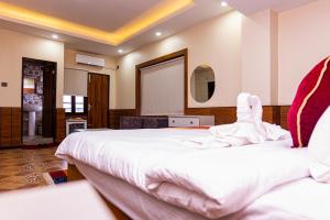 Voodi või voodid majutusasutuse Hotel Palazzo toas