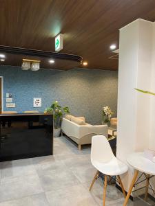 a lobby with a couch and a table and chairs at MR TOMO FUJI in Fuji