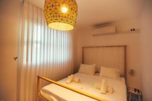 a bedroom with a bed and a chandelier at Hotel Anilevich Mansion in Beer Sheva