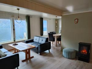 a living room with a couch and a fireplace at Visit Undredal in Undredal