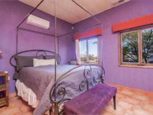 a bedroom with a bed and a purple wall at Casa Roja Rental Home - Taste of San Felipe in San Felipe +25 photos