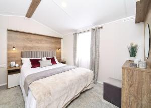 a bedroom with a large bed and a large window at Witton Castle Country Park in Bishop Auckland