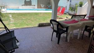 a patio with a table and chairs and a pool at Casa Rava in Santiago del Estero