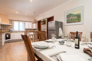 a kitchen and dining room with a table and chairs at NEW!Villa SESPIGA in Portocolom