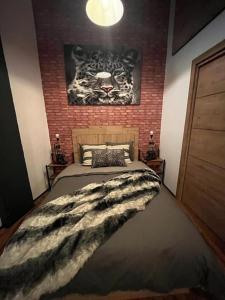 ein Schlafzimmer mit einem Bett mit einem Tiger-Gemälde an der Wand in der Unterkunft Industrial Loft estudio in Estepona
