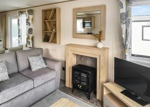 a living room with a couch and a fireplace at Witton Castle Country Park in Bishop Auckland