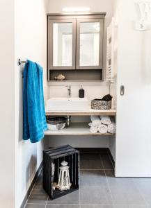 a bathroom with a sink and a blue towel at Perlekieker 1 in Büsum +12 photos