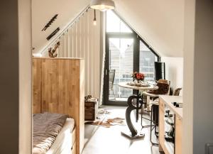 a room with a staircase with a table and a window at Achtern Diek in Büsum