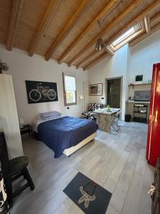 a bedroom with a bed and a desk with a bike on the wall at CASETTO ROSSO in San Lazzaro di Savena