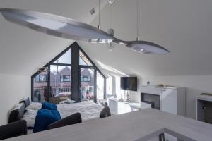a living room with a table and a large window at Steife Brise in Büsum +9 photos