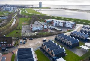 an aerial view of a city with a body of water at Steife Brise in Büsum